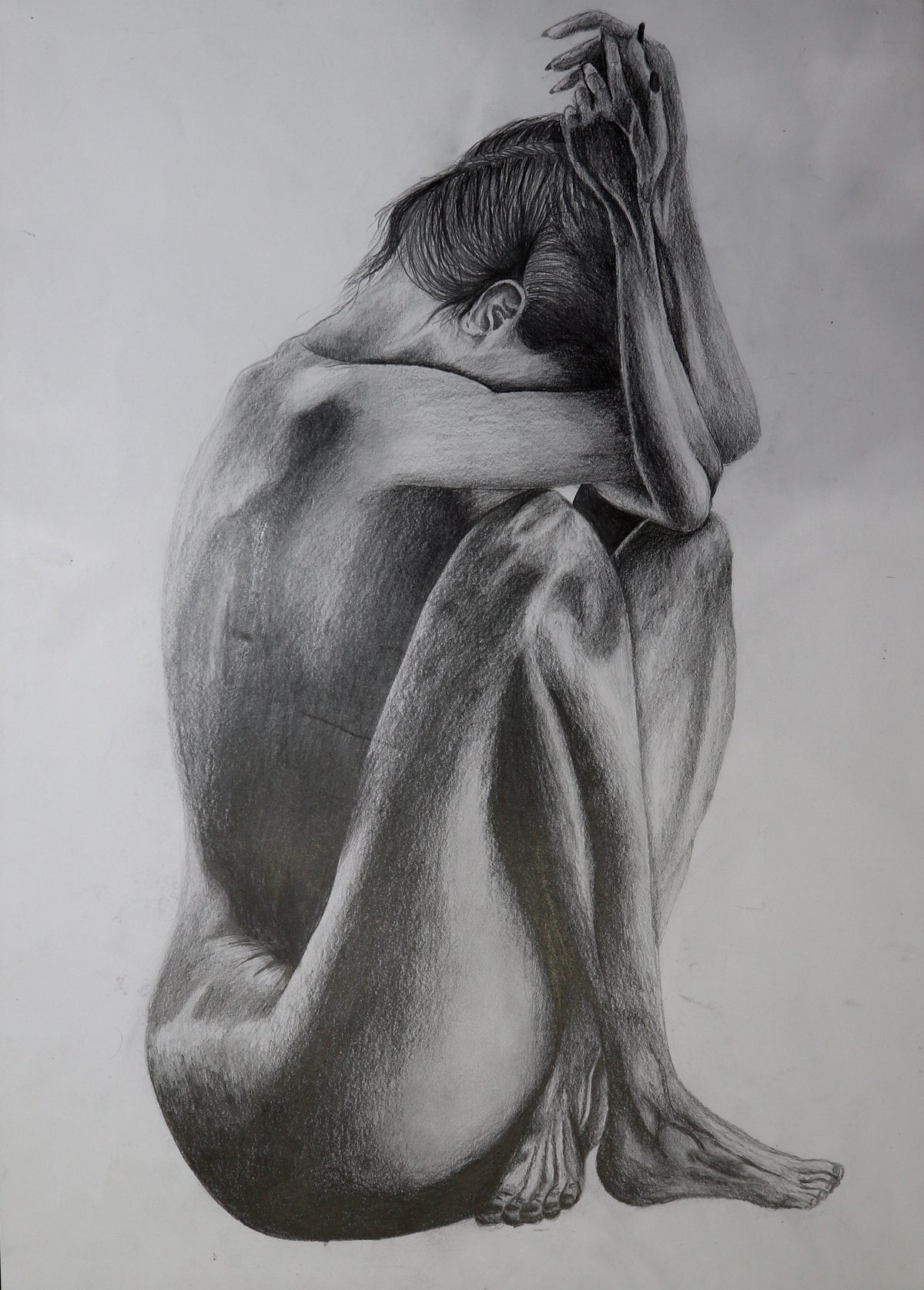 Original pencil drawing on A3 paper — seated figure, head bowed, pencil on paper
